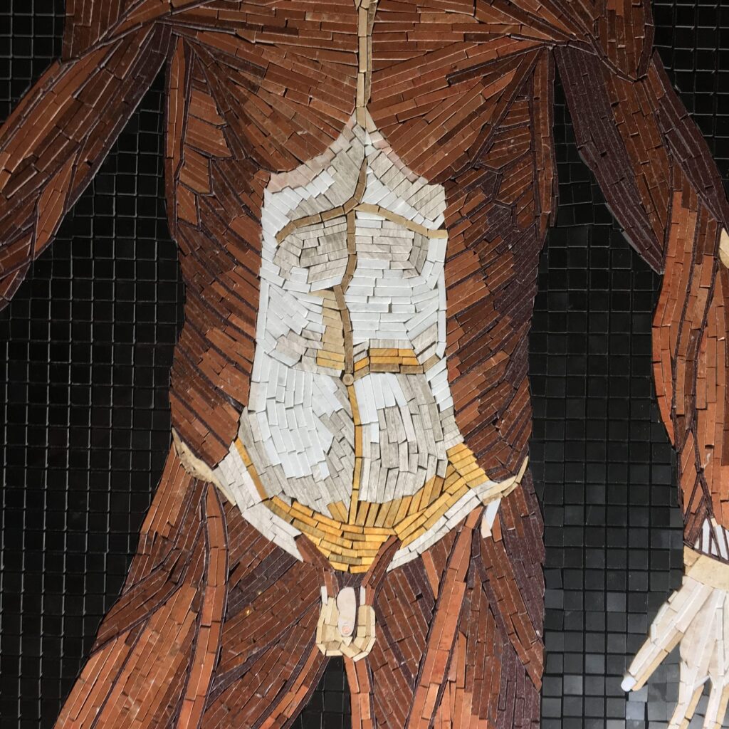 The torso of Table 30 in progress, the abdomen laid in striated limestone colored with rust