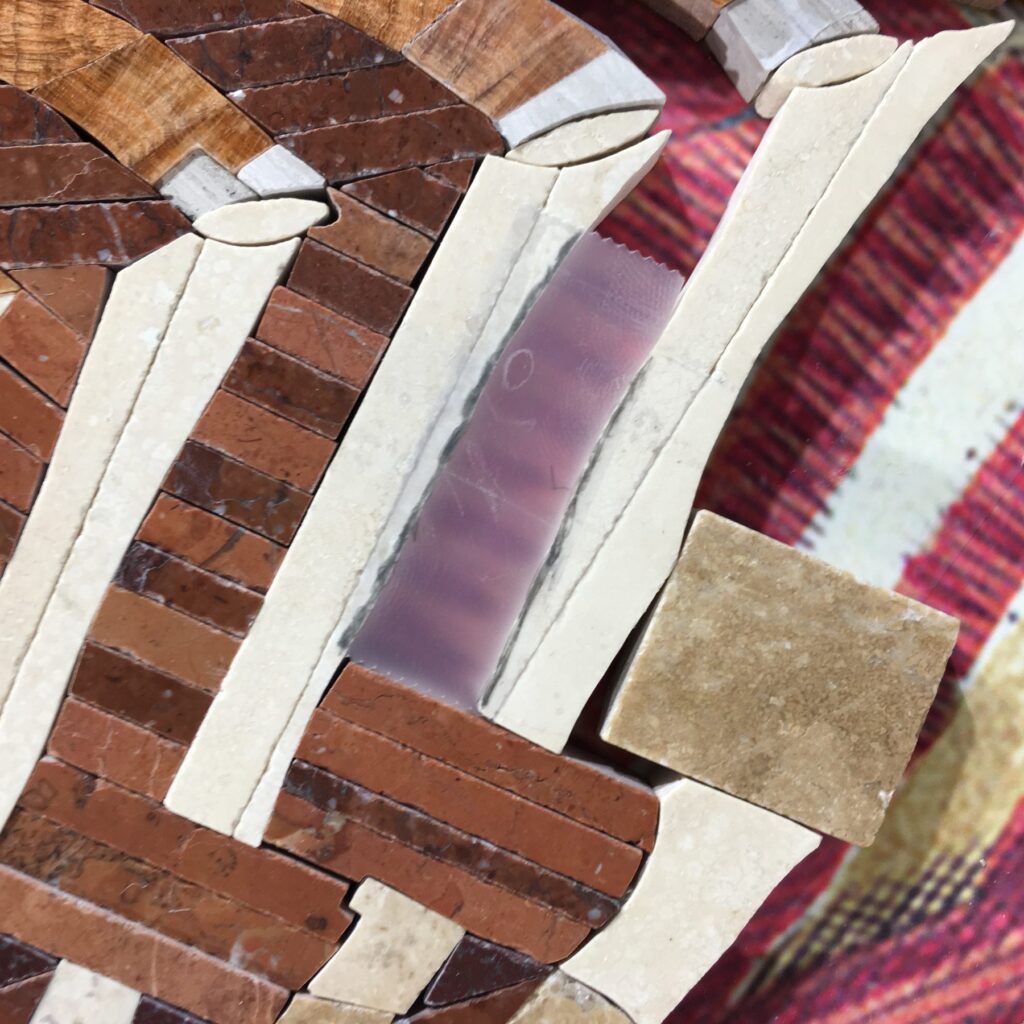 Scotch tape marked in place above set stone, the drawing a cut will be made from